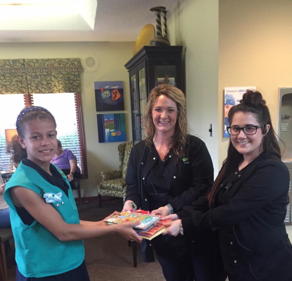 Jessica & Sulina accepted children's books today from Johanna and the Girl Scouts!